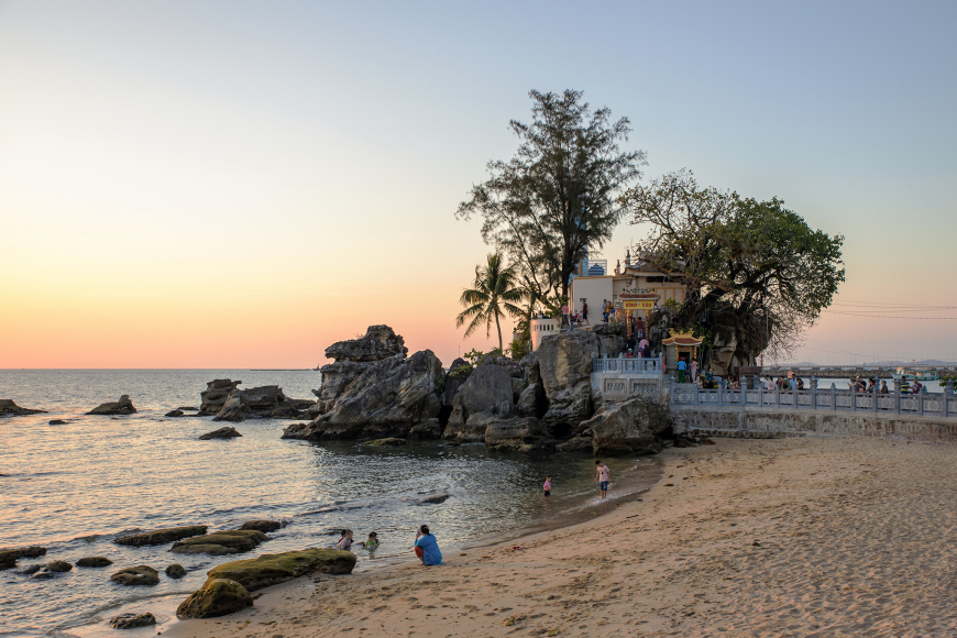 Sunset at Dinh Cau Temple with the harbor in the background